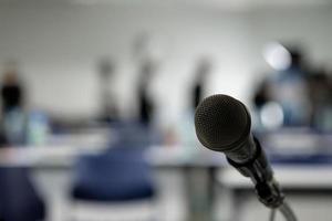 Microphone on the abstract blurred photo of seminar room background