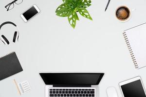 Modern workspace with laptop tablet, smartphone and coffee cup copy space on color background. Top view. Flat lay style. photo