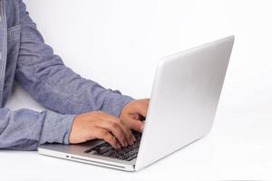 Hands typing on keyboard of laptop on white background photo