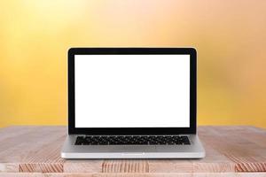 Front view of the laptop is on the work table with bokeh green background photo