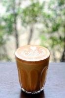 Coffee latte art on wood table photo