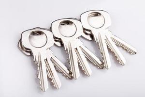 Set of old house keys  on white background photo