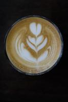 Coffee latte art on black table, Top view photo