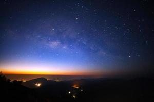 Milky Way Galaxy with light city before sunrise at Doi inthanon Chiang mai, Thailand. photo