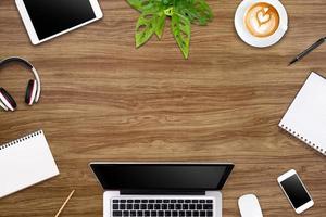 Modern workspace with laptop tablet, smartphone and coffee cup copy space on color background. Top view. Flat lay style. photo