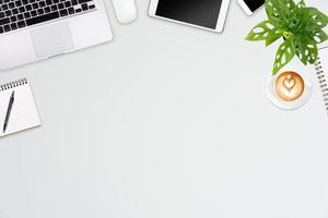 Modern workspace with laptop tablet, smartphone and coffee cup copy space on color background. Top view. Flat lay style. photo