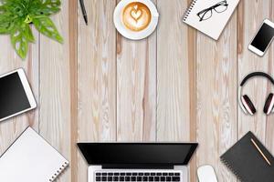 Modern workspace with laptop tablet, smartphone and coffee cup copy space on color background. Top view. Flat lay style. photo