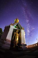 Milky Way at Standing gold Buddha image name is Wat Sra Song Pee Nong in Phitsanulok, Thailand