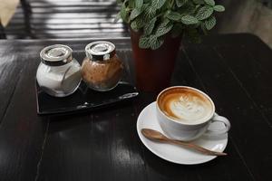 Cup of latte coffee on wooden table photo