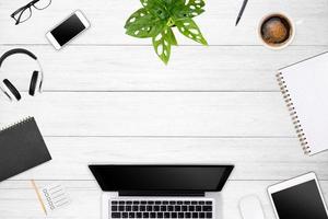 Modern workspace with laptop tablet, smartphone and coffee cup copy space on color background. Top view. Flat lay style. photo