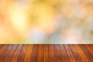 Wood table top on bokeh orange background - can be used for montage or display your products photo