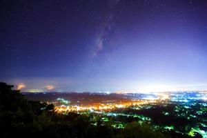 City landscape at nigh with Milky Way galaxy, Long exposure photograph photo