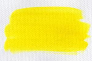 Abstract yellow watercolor on white background.The color splashing on the paper.It is a hand drawn. photo