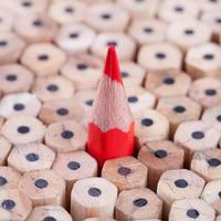 One sharpened red pencil among many ones photo