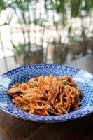 spaghetti seafood tomato sauce on wood table photo