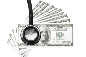 Health care costs. Stethoscope and money symbol for health care costs or medical insurance photo