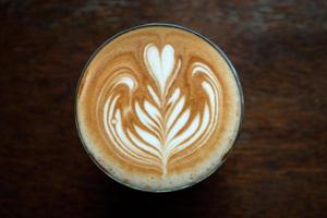 Top view, coffee latte art on wood table photo