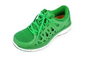 green sport running shoes isolated on white background photo