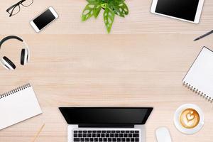 Modern workspace with laptop tablet, smartphone and coffee cup copy space on color background. Top view. Flat lay style. photo