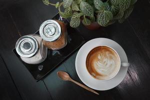 Cup of latte coffee on wooden table photo