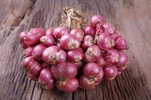 red onions on wood background photo