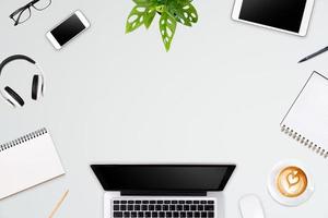 Modern workspace with laptop tablet, smartphone and coffee cup copy space on color background. Top view. Flat lay style. photo