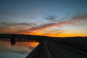 Silhouette sunset with cloud at Khwae Noi Bamrungdan dam in Phitsanulok province, Thailand photo