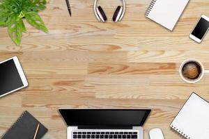 Modern workspace with laptop tablet, smartphone and coffee cup copy space on color background. Top view. Flat lay style. photo