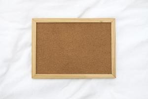 Wooden frame for photo on the fabric background