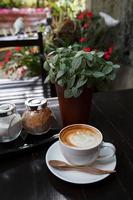 Cup of latte coffee on wooden photo