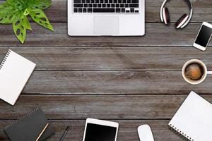 Modern workspace with laptop tablet, smartphone and coffee cup copy space on color background. Top view. Flat lay style. photo