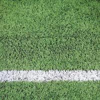 White stripe on the green football field photo