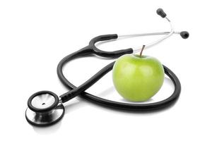 stethescope and apple on white background photo