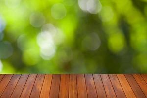 natural green bokeh background with wooden paving photo