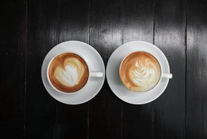 latte art coffee on wood background photo