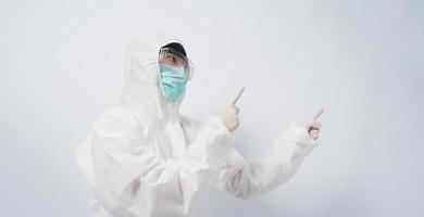 Doctor in PPE suit gesture make hand sign. Represent victory win over virus. photo