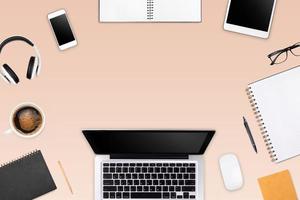 Modern workspace with laptop tablet, smartphone and coffee cup copy space on color background. Top view. Flat lay style. photo