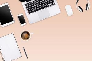 Modern workspace with laptop tablet, smartphone and coffee cup copy space on color background. Top view. Flat lay style. photo