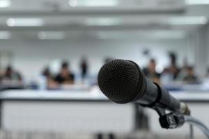 Microphone on the abstract blurred photo of seminar room background