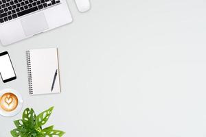 Modern workspace with laptop tablet, smartphone and coffee cup copy space on color background. Top view. Flat lay style. photo