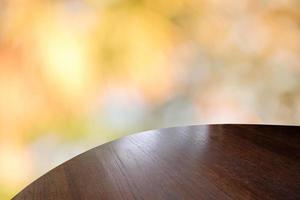 Wood table top on bokeh orange background - can be used for montage or display your products photo