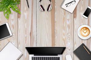 Modern workspace with laptop tablet, smartphone and coffee cup copy space on color background. Top view. Flat lay style. photo