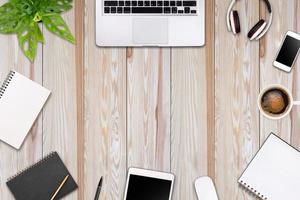 Modern workspace with laptop tablet, smartphone and coffee cup copy space on color background. Top view. Flat lay style. photo