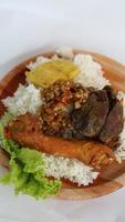 Indonesian lalapan rice which contains chicken head and chicken liver which is very delicious photo