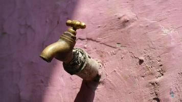 The brown water faucet is old but still works photo