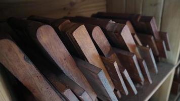 Stacks of small brown folding tables for learning the Koran photo