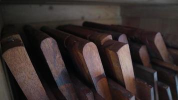 Stacks of small brown folding tables for learning the Koran photo