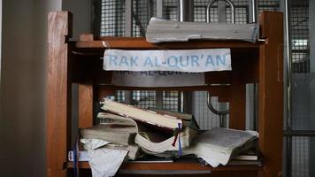 Stacks of small brown folding tables for learning the Koran photo