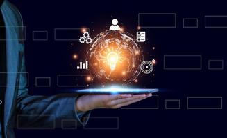 Businessman conducting online transactions with internet technology. Concept global data connection by metaverse technology , big data , search for information, e-commerce, online business.On tablet. photo