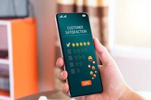 Customer satisfaction assessment concept. customer show smartphone screen send satisfaction rate five stars, send smiley emoji and hearts, satisfied smiley face, excellent service, customer be happy. photo